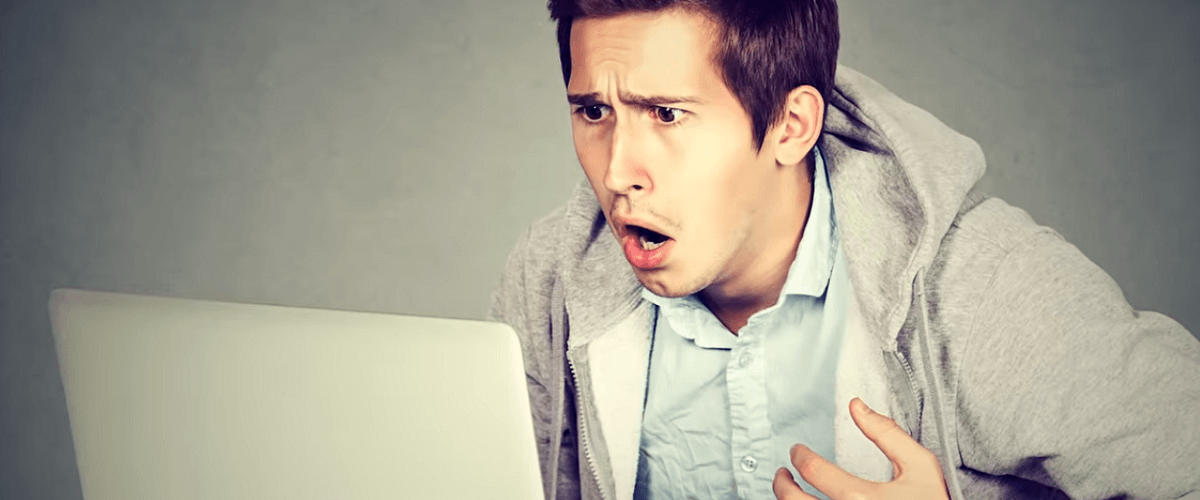 a man wearing a sweater in shock